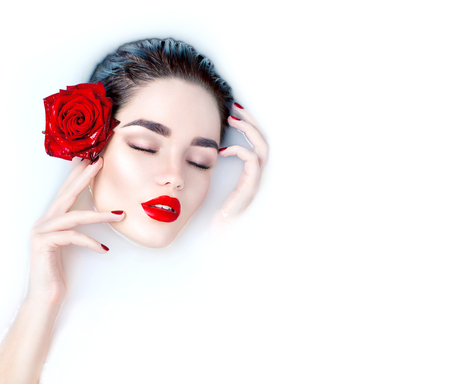 Beautiful Fashion model girl taking milk bath, spa and skin care conceptの写真素材