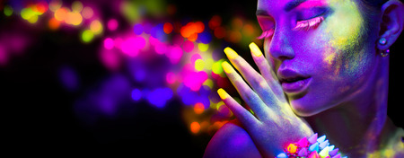 Beauty woman in neon light, portrait of beautiful model with fluorescent makeupの写真素材