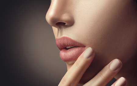 Beauty sexy woman with natural makeup and beige nail polishの写真素材