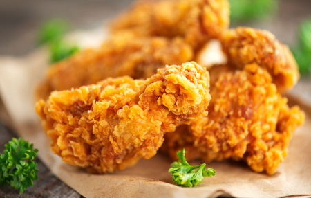 Crispy fried kentucky chicken wings on wooden tableの写真素材
