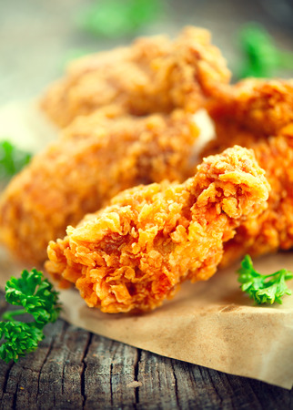 Crispy fried kentucky chicken wings on wooden tableの写真素材