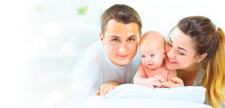 Happy young family. Father, mother and their newborn baby. Parenthood concept