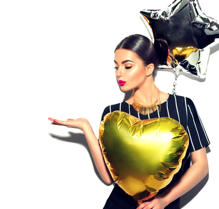 Beauty model girl with colorful balloons showing empty copy space on open hand palm for textの写真素材