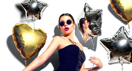 Party. Beauty model girl with colorful heart and star shaped balloons isolated on white backgroundの写真素材