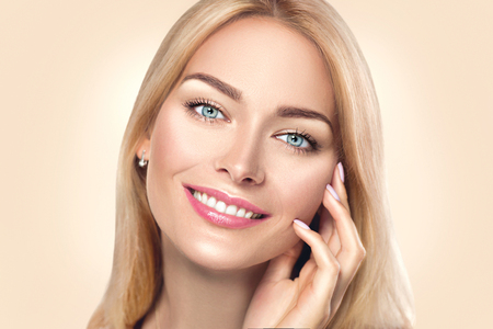 Beauty spa woman touching her face and smiling. Skincare concept