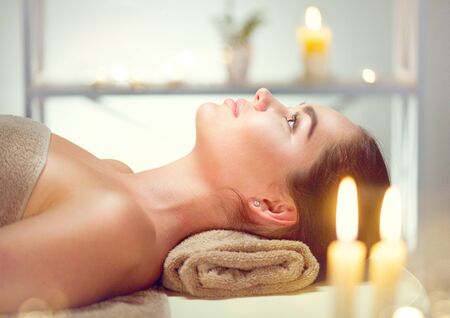 Spa. Beauty brunette woman relaxing in spa salonの写真素材