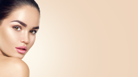 Beauty woman face. Beautiful brunette young model girl with perfect skin. Skincare conceptの写真素材
