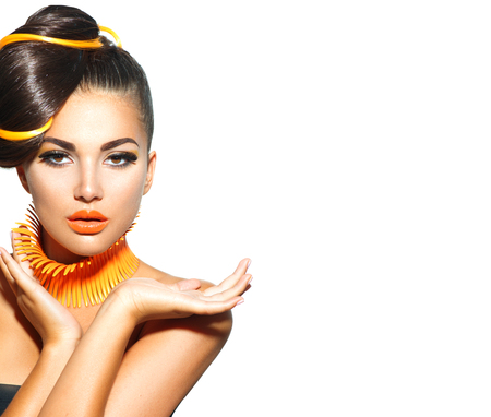 Fashion model girl with yellow and orange makeup. Creative hairstyleの写真素材