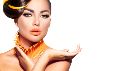 Fashion model girl with yellow and orange makeup. Creative hairstyleの写真素材