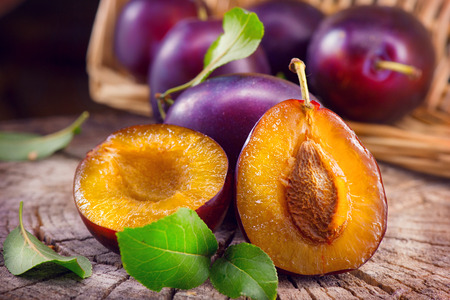 Plum. Juicy ripe organic plums closeup, over wooden backgroundの写真素材