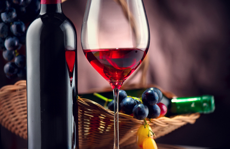 Wine. Bottle and glass of red wine with ripe grapesの写真素材