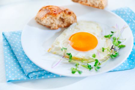 Healthy breakfast. Fried heart shaped egg closeupの写真素材