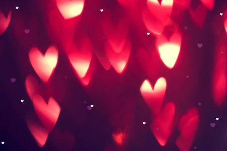Valentine's Day background. Holiday abstract background with red glowing heartsの写真素材