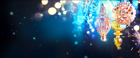 Christmas and New Year golden decorations over blinking night background. Wide angleの写真素材