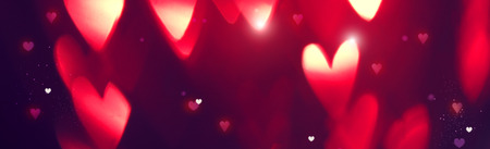 Valentine's Day background. Holiday abstract background with red glowing heartsの写真素材