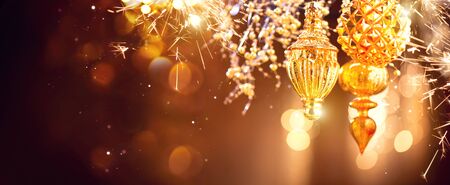 Christmas and New Year golden decorations. Abstract blinking holiday background. Wide angleの写真素材