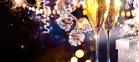 Christmas scene. Flutes with sparkling champagne over holiday backgroundの写真素材