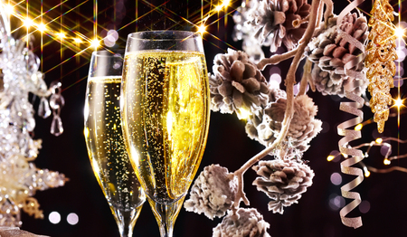 Christmas scene. Flutes with sparkling champagne over holiday backgroundの写真素材