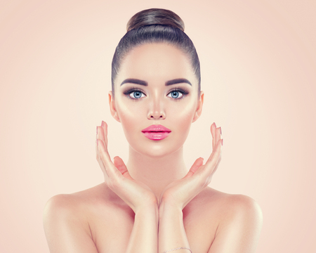Beauty woman portrait. Pretty young woman touching her face. Skincareの写真素材