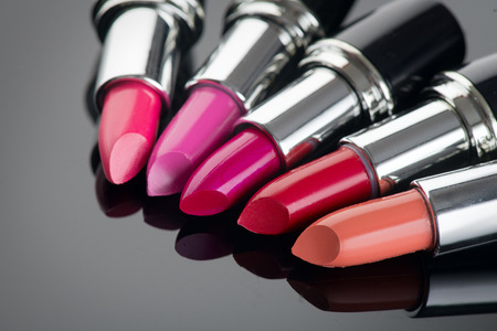 Lipstick. Professional makeup and beauty. Lipstick tints palette closeup. Colorful lipsticks over black backgroundの写真素材