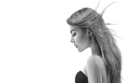 Fashion model girl with long blowing hair. Black and white portrait. Beauty woman isolated on white background. Fluttering hairの写真素材