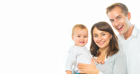 Happy family portrait. Father, mother and their little baby together isolated on white background. Parenthood conceptの写真素材