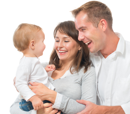 Happy family portrait. Father, mother and their little baby together isolated on white background. Parenthood conceptの写真素材