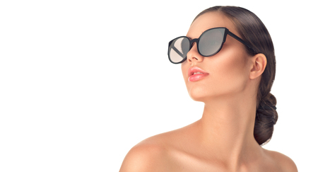 Beauty fashion model girl wearing sunglasses. Beautiful woman portrait over white backgroundの写真素材