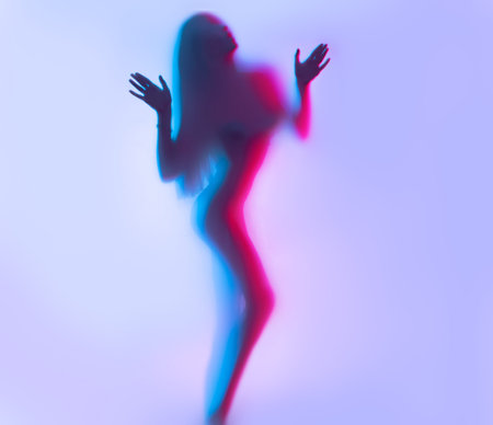 Beauty model girl dancing silhouette. Beautiful sexy young woman with perfect slim body dance in uv...