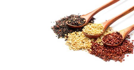 Quinoa. Red, black and white quinoa grains in a wooden spoons isolatedの写真素材