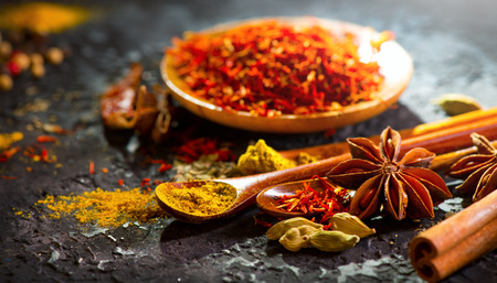 Spices. Various Indian spices on black stone table.の写真素材