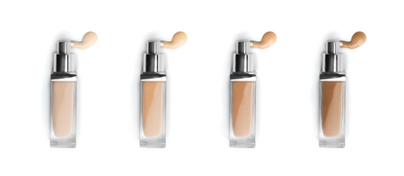 Foundation face makeup samples. Set of cosmetic liquid foundation or bb cream in bottles. Different colour smudge smear strokes isolated on white. Foundation colors paletteの写真素材