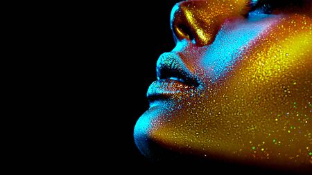 Fashion model woman skin face in bright sparkles, colorful neon lights, beautiful sexy girl lips, mouth.の写真素材