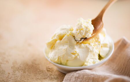 Mascarpone cream cheese closeup. Mascarpone soft milk cream in white bowl. Homemade ice cream, yoghurtの写真素材