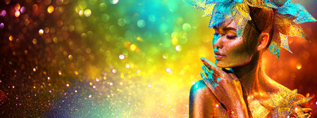 Golden Fashion model woman with bright golden sparkles on skin posing, fantasy flower, portrait of beautiful girl glowing makeup. Art design gold sequins make up. Glitter glowing skin, jewellery, neonの写真素材