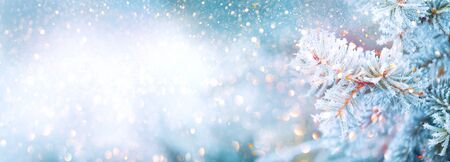 Christmas winter blurred background. Xmas tree with snow decorated with garland lights, holiday festive background. Widescreen backdrop. New year Winter art design, wide screen holiday borderの写真素材