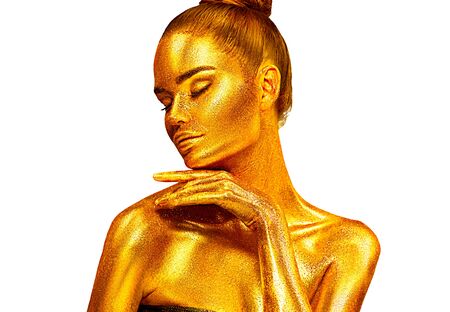 Fashion art Golden skin Woman face Beauty gold metallic body portrait isolated on white background. Christmas Model girl with holiday golden Glamour shiny makeup. Gold jewellery, jewelry, accessoriesの写真素材