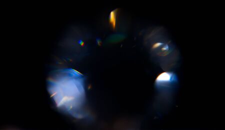 Lens Flare, Abstract Bokeh Lights. Leaking Reflection of a Glass, Crystal, Defocused Shining Colorful rainbow Light Leaks, Rays on Black Backgroundの写真素材