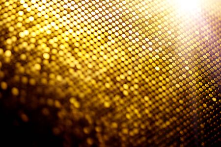 Abstract gold particle  backdrop with glowing golden dotsの写真素材