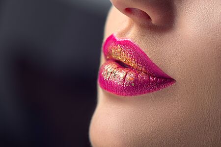 Lips make-up. Beauty high fashion trendy gradient lips makeup sample, purple with golden color, sexy mouth closeup. Lipstick. Professional Make up artist workの写真素材