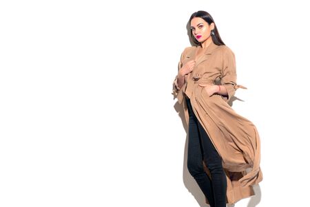 Beauty model girl posing in fashionable spring clothes, wear, apparel.  Beautiful young brunette woman in trendy outfit, fashion make up and accessories isolated on white background Urban street styleの写真素材