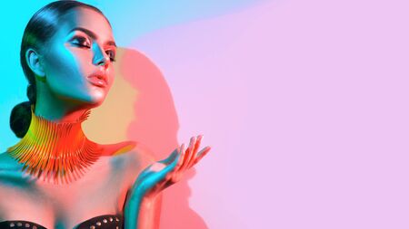 High Fashion model woman portrait in colourful bright neon lightsの写真素材