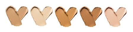 Foundation smears palette close-up. Heart shaped make-up smudge, smear. Cosmetic liquid bb cream beige color smudges, strokes. Colorful Liquid Make up concealer isolated on white background.の写真素材