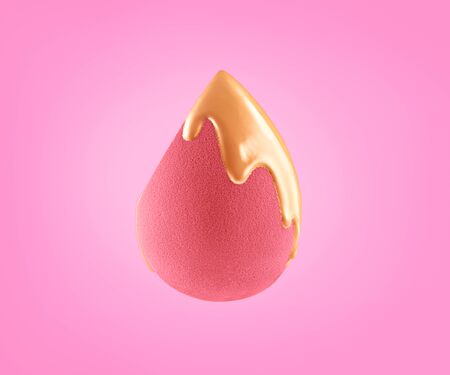 Makeup liquid foundation pouring on make-up blender sponge, closeup.の写真素材