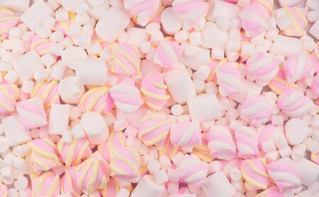 Marshmallow. Close-up of various colourful Marshmallows colorful chewy candy backdrop, colorful pink with white and yellow background. Sweet food dessert backdrop, closeup. Top view, flatlay.の写真素材