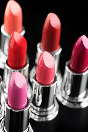 Lipstick. Fashion Colorful Lipsticks over black background. Lipstick tints palette, Professional Makeup and Beauty. Beautiful Make-up concept. Lipgloss. Vertical imageの写真素材