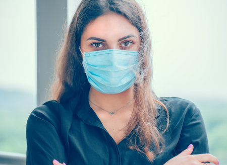 Young woman wearing her protective mask and breathes in clean air.  Coronavirus, Covid-19 flu virus...
