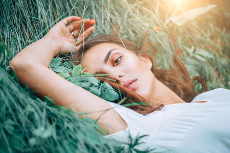 Young woman lying on the grass.の写真素材