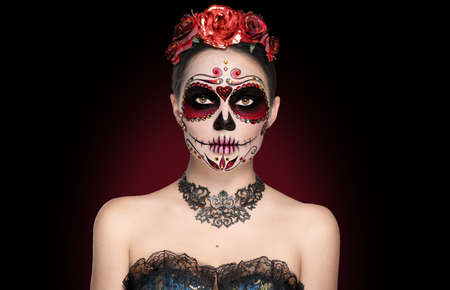 Sugar skull makeup. Halloween party, traditional Mexican carnival, Santa Muerte. Beautiful young woman costume, painted faceの写真素材