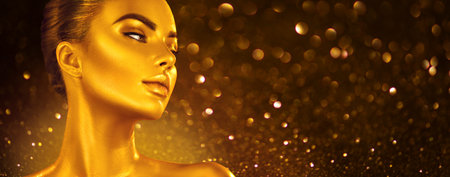 Golden skin make-up, Woman face portrait closeup. Model girl with holiday golden Glamour shiny professional make up. Gold jewellery, jewelry, accessories. Beauty gold metallic body, fashion Xmas artの写真素材